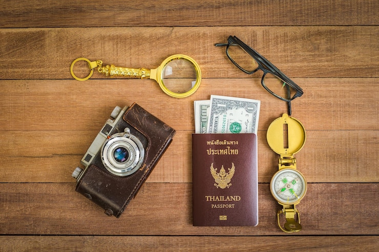 Photo directly above shot of passport with vintage camera on table