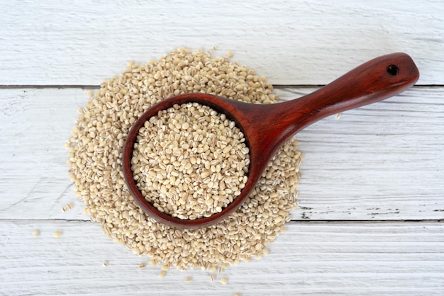 Directly above shot of pearl barley in wooden scoop