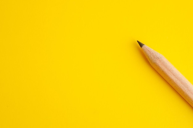 Photo directly above shot of pencil on yellow background