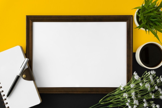 directly above shot of picture frame by coffee and book on table