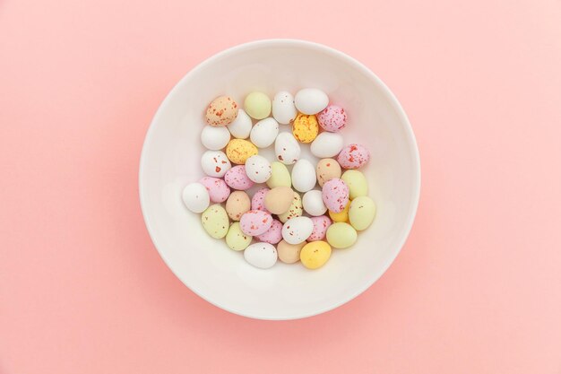 Directly above shot of pills in bowl against pink background