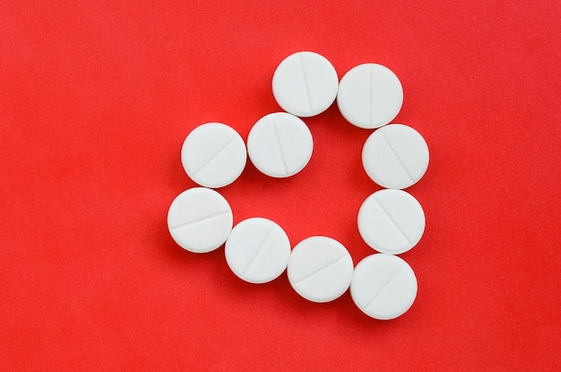 Directly above shot of pills on red background