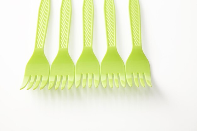 Photo directly above shot of plastic forks over white background