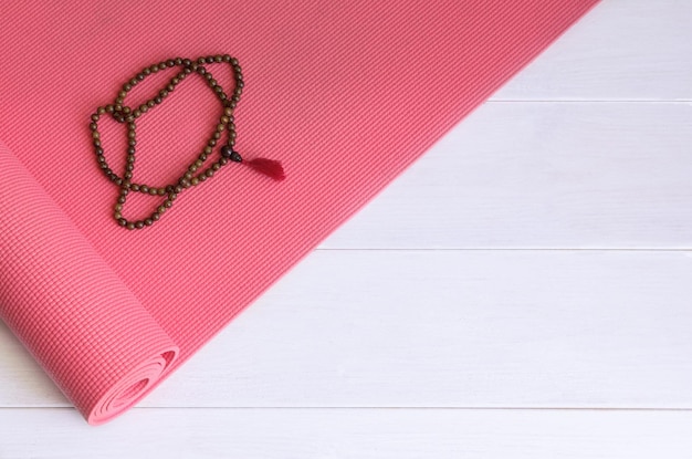 Directly above shot of prayer beads over mat on table