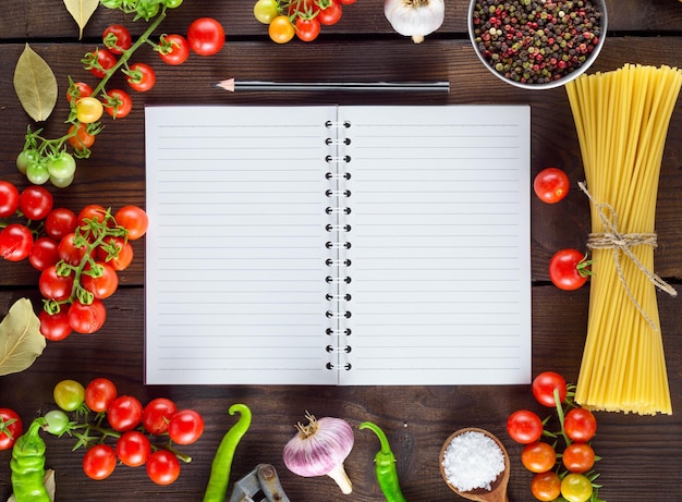 Directly above shot of raw food with note pad on table