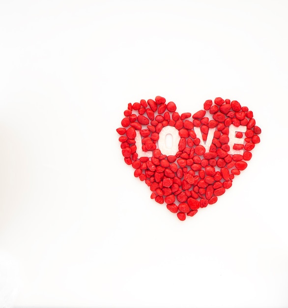 Photo directly above shot of red heart shape against white background