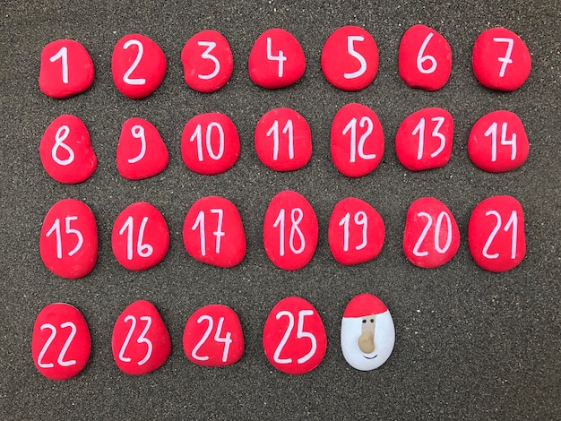 Photo directly above shot of red pebbles with numbers arranged