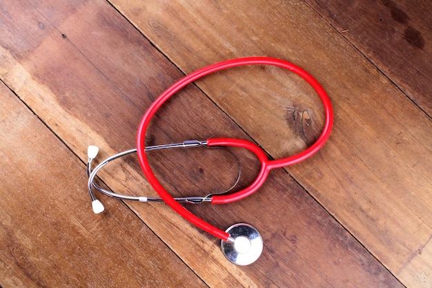 Photo directly above shot of red stethoscope on table