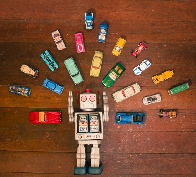 Photo directly above shot of robot with small toy cars