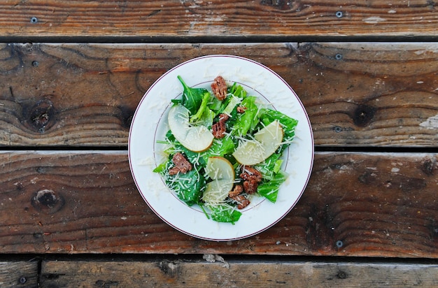 Directly above shot of salad in plate on wooden table