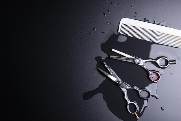 directly above shot of salon equipment with water over black background