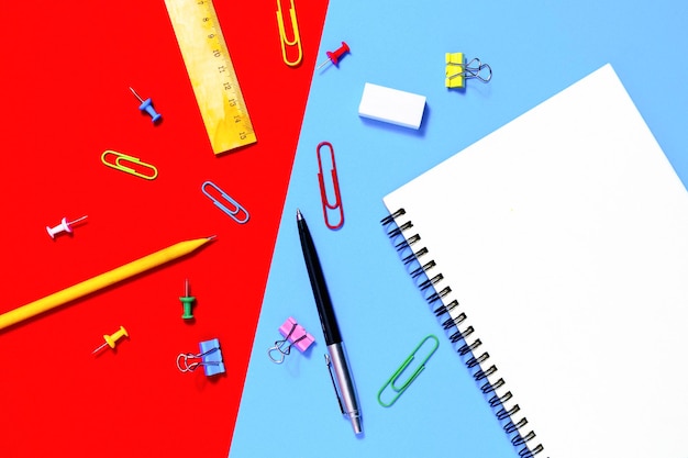 Directly above shot of school supplies against two tone background