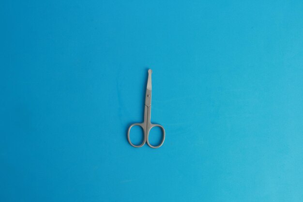 Photo directly above shot of scissors on blue background