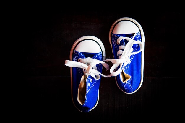 Photo directly above shot of shoes against black background