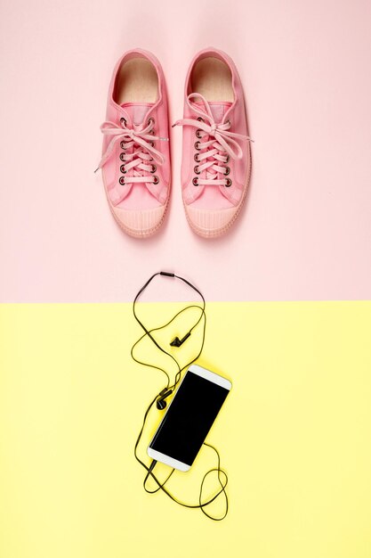 Photo directly above shot of shoes and mobile phone over colored background