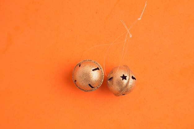 Directly above shot of small bells on orange background