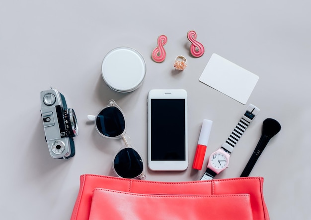 Photo directly above shot of smart phone with camera and beauty products on table