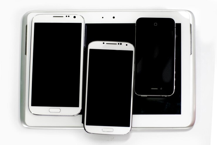 Photo directly above shot of smart phones on digital tablet at desk