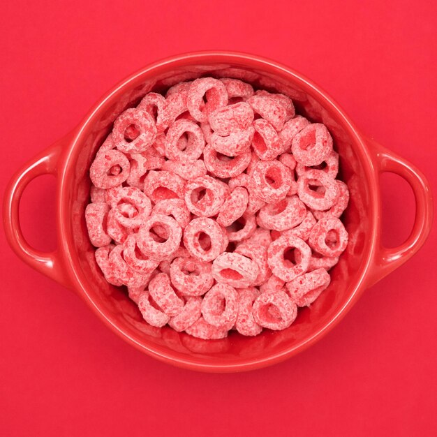 Directly above shot of snack in bowl on red background