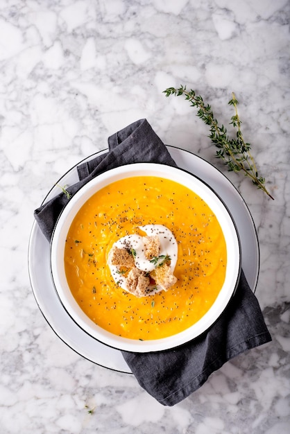 Photo directly above shot soup served in bowl on table