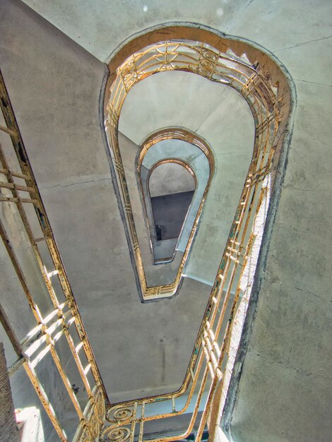 Photo directly below shot of spiral staircase in abandoned hospital