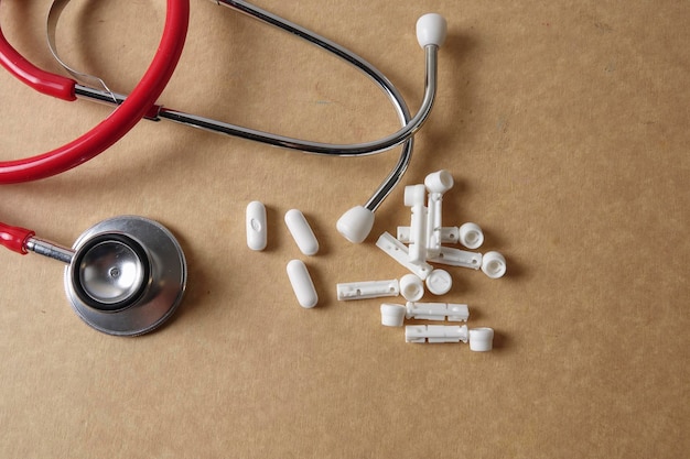 Directly above shot of stethoscope and medicines on brown table