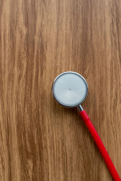 Photo directly above shot of stethoscope on wooden table