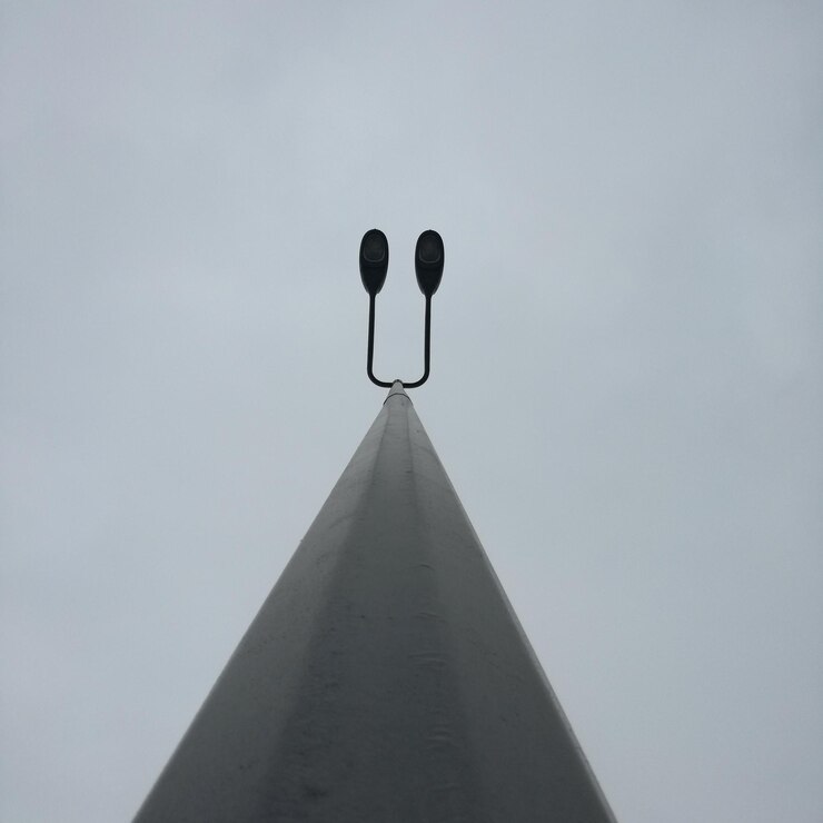 Photo directly below shot of street light against clear sky