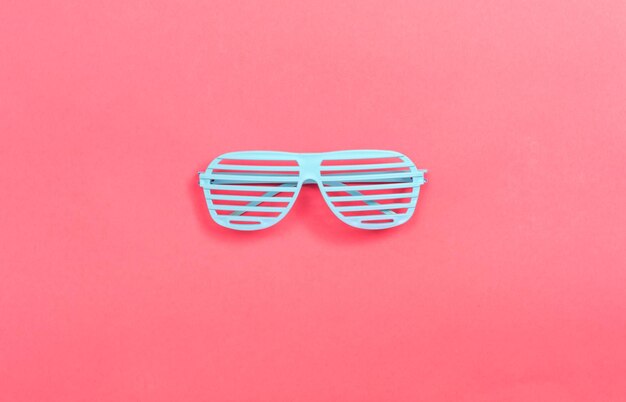 Photo directly above shot of sunglasses against pink background