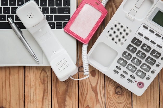 Photo directly above shot of telephone with laptop on office desk