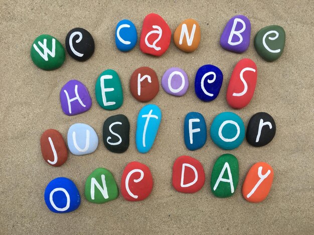 Photo directly above shot of text on multi colored stones at beach