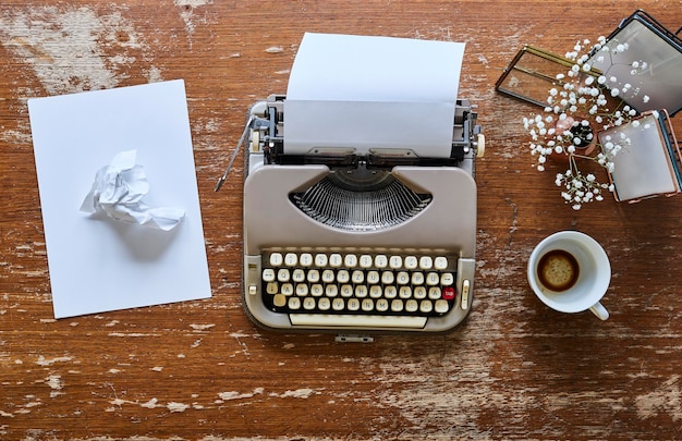 Photo directly above shot of typewriter and cup on table