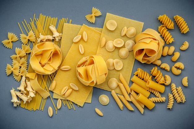 Photo directly above shot of various pastas on gray table