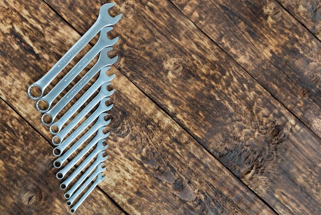 Photo directly above shot of various spanners on wooden table