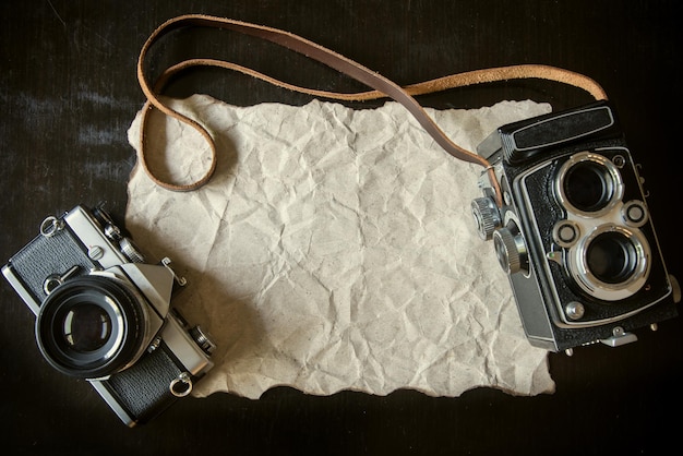 Photo directly above shot of vintage cameras and paper on table