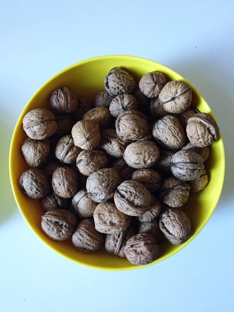 Photo directly above shot of walnuts in bowl on white background