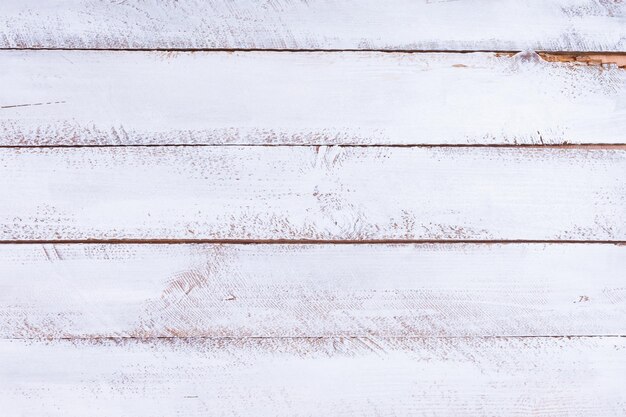 Directly above shot of white paint on wooden table