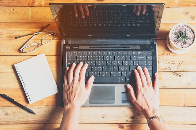 Photo directly above shot of woman using laptop on table