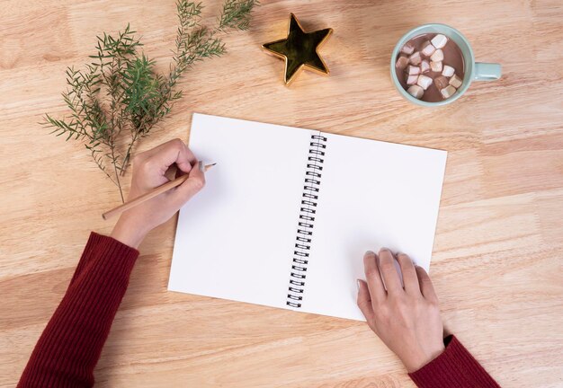 Photo directly above shot of woman writing in notepad