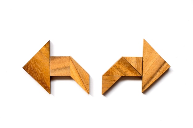 Photo directly above shot of wooden blocks arranged in arrow symbols against white background