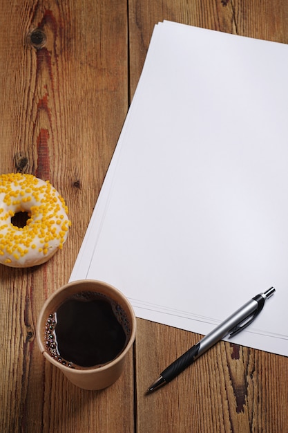 Directly above view of empty paper, coffee and donut