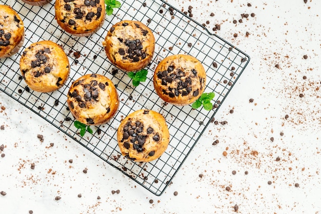 Photo directly above view of fresh muffins with chocolate chips on cooling rack