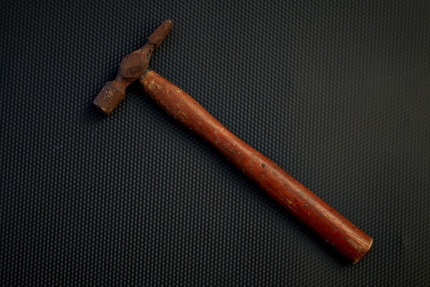 Photo directly above view of hammer on black table