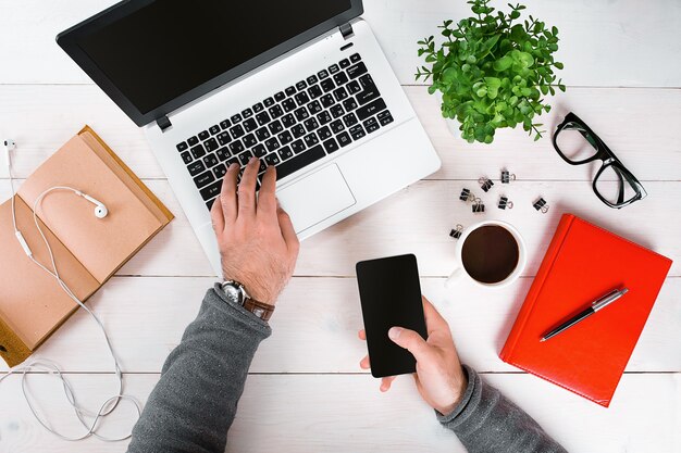 Directly above view of human hands typing on laptop