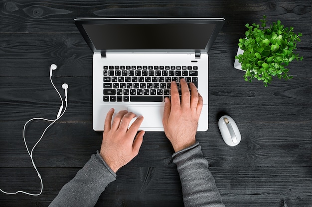 Directly above view of human hands typing on laptop