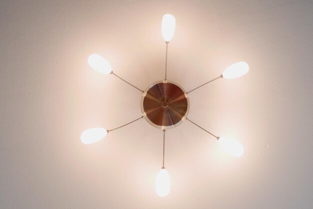 Photo directly below view of illuminated light fixture on ceiling