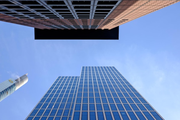 Directly below view of modern buildings in city against sky
