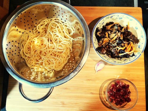 Photo directly above view of mushrooms and spaghetti pasta