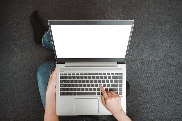 Photo directly above view of person using laptop on table