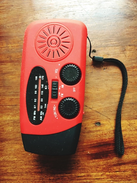 Directly above view of red radio on table
